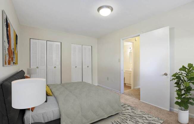 A bedroom with a bed, a lamp, and a painting on the wall.