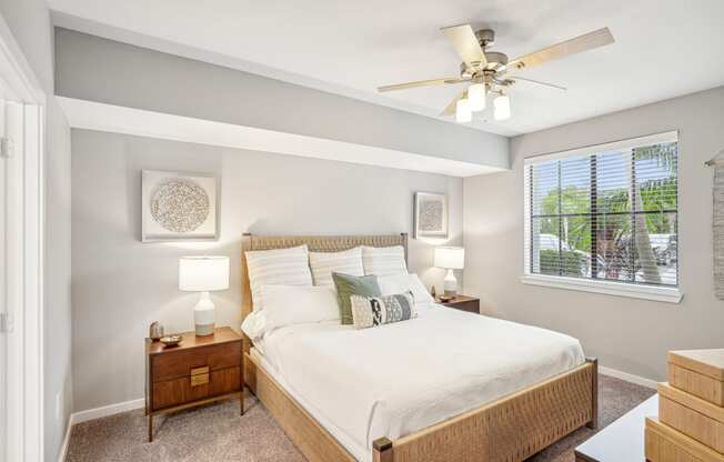 a bedroom with a large bed and a ceiling fan