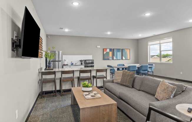 a living room with a couch and a table with chairs