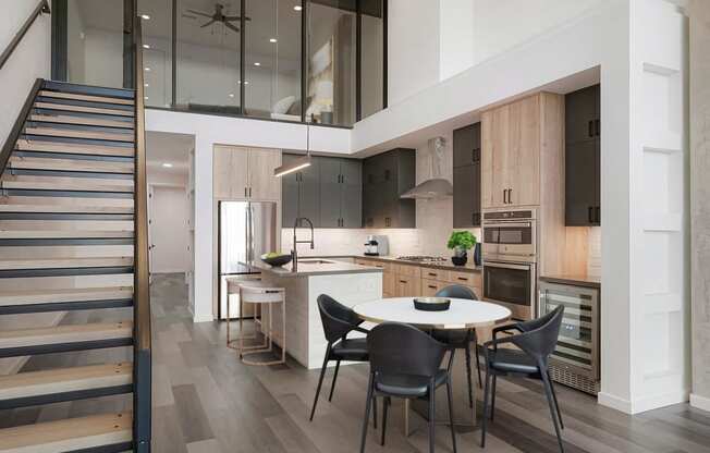 a kitchen and dining area with a white table and chairs