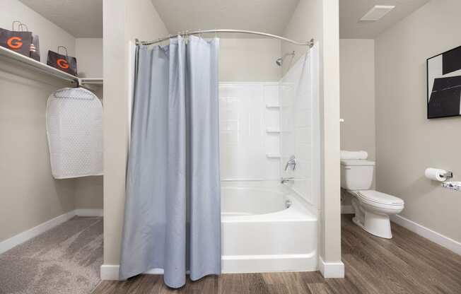 a bathroom with a bathtub and a toilet in a 555 waverly unit