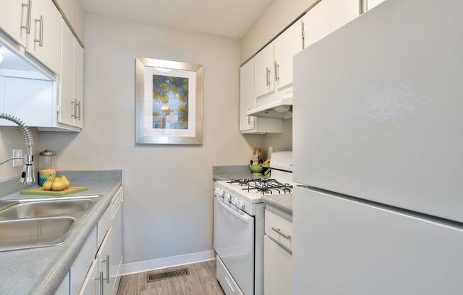 Park at Idlewild Apartments kitchen with white appliances and white cabinets