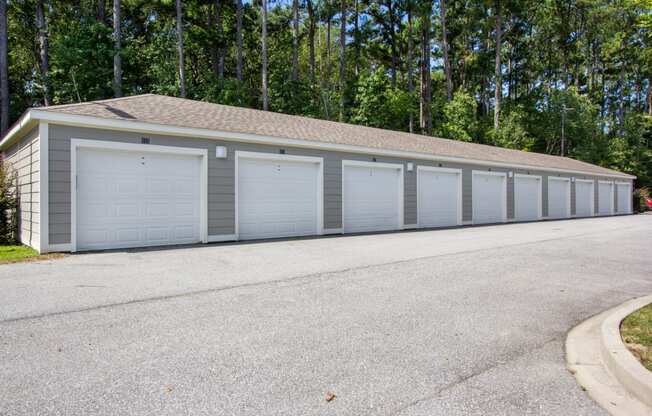 a garage with a row of doors on the side of a street