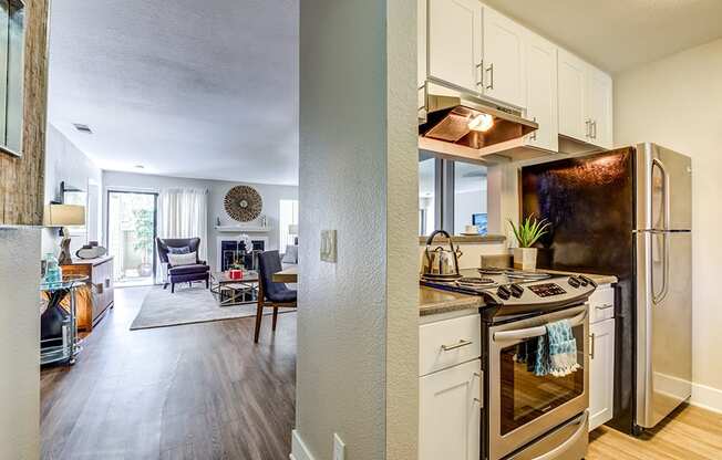 Apartments in Pittsburg CA - Spacious Kitchen with Stylish Interior and Modern Amenities Such as Microwave, Stove, and Refrigerator