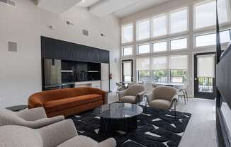a living room with a couch and chairs and a table
