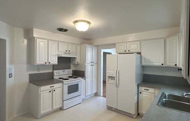 Model three bedroom home, with well-maintained yard & attached garage!