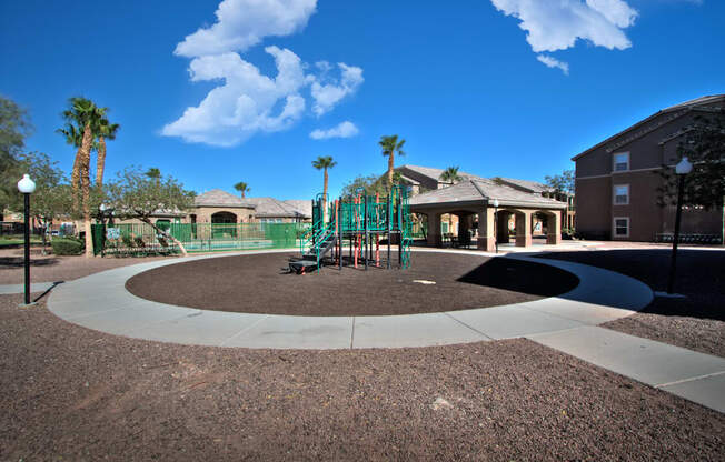 a playground in a park with a building in the background