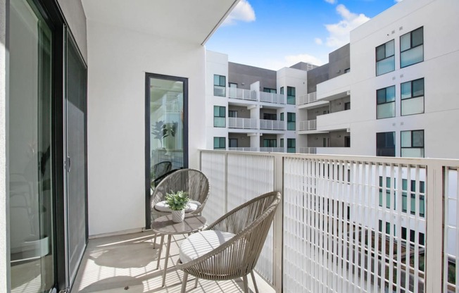 a balcony with two chairs and a table