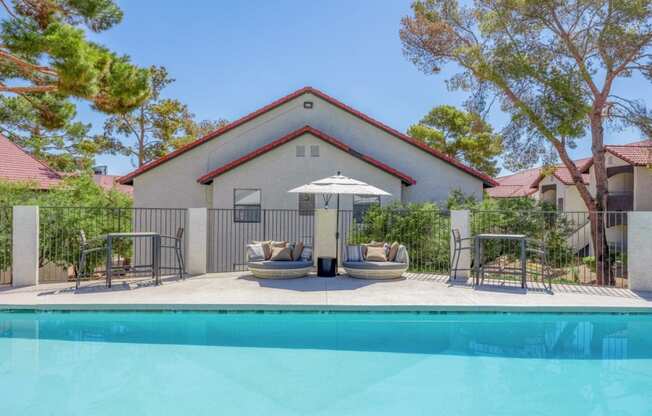 a pool with chairs and an umbrella