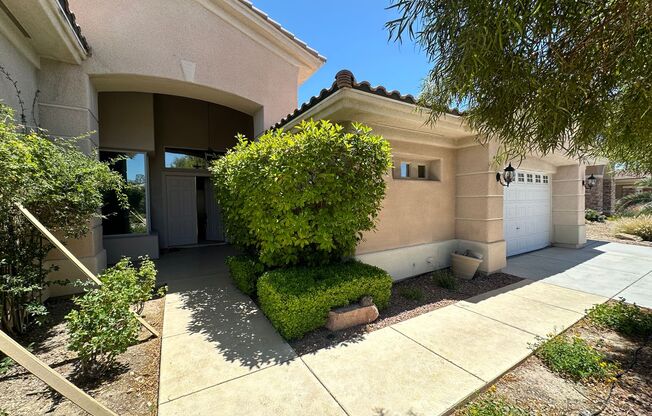 Stunning single story solar powered home with pool in gated community.