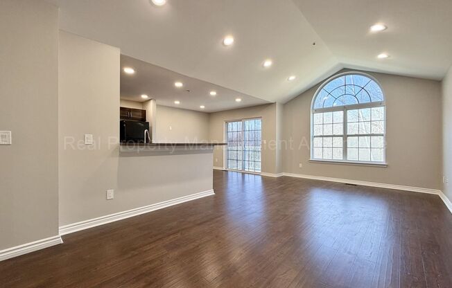 Rare Corner Upper Condo with Vaulted Ceilings, Private Balcony and 2 Car Garage - Right Across from the GM Tech Center!
