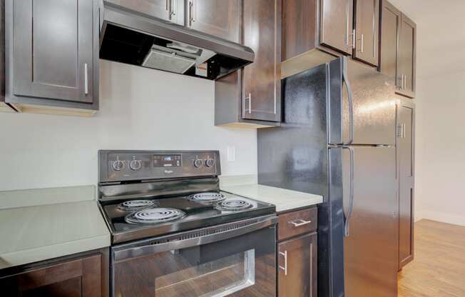 an empty kitchen with stainless steel appliances and wooden cabinets at Copper Pines, Bozeman, MT, 59718