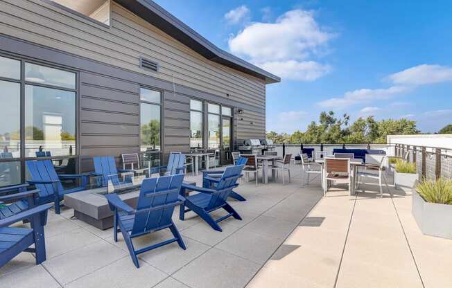 the patio of the building has blue chairs and tables at Barrington 101, Chicago