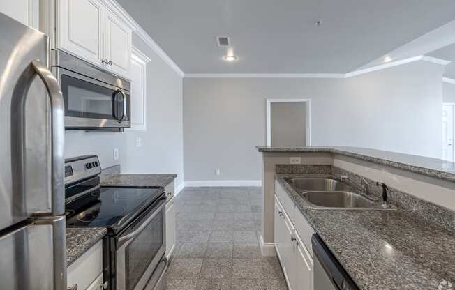 a kitchen with granite counter tops and stainless steel appliances