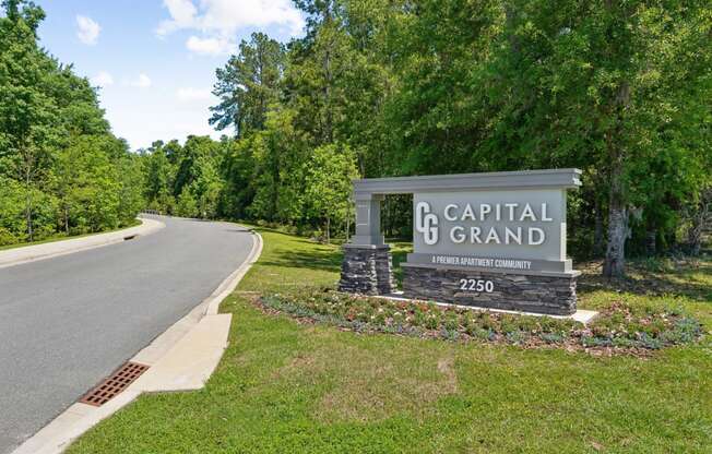 Capital Grand sign on the side of a road at Capital Grand Apartments in Tallahassee, FL