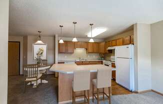 Kitchen with Wood Cabinetry at Sunset Ridge Apartments in Bismarck, ND