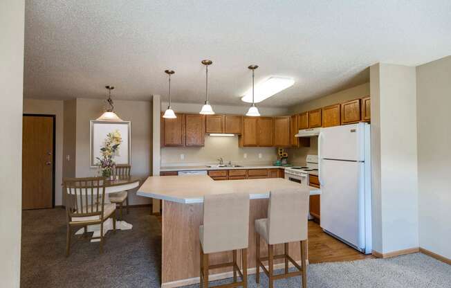 Kitchen with Wood Cabinetry at Sunset Ridge Apartments in Bismarck, ND