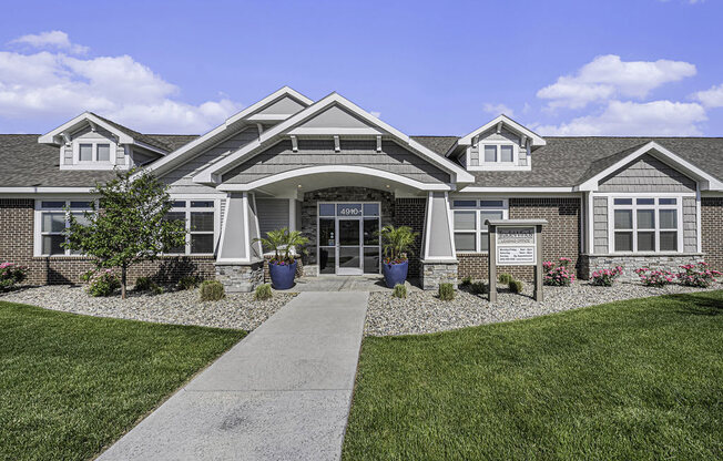 a large house with a sidewalk in front of it