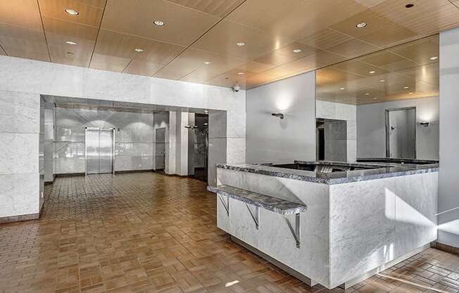 a large room with a large counter and a stainless steel refrigerator