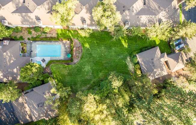 a birdseye view of a house with a large backyard