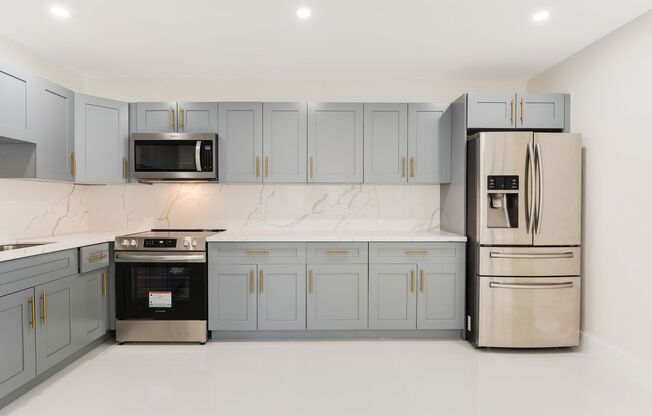 Fully renovated stylish 3 bed 2 bath home featuring a luxury kitchen, modern appliances on a fenced lot with parking!