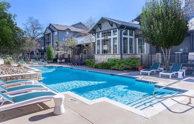 a group of lawn chairs sitting next to a pool