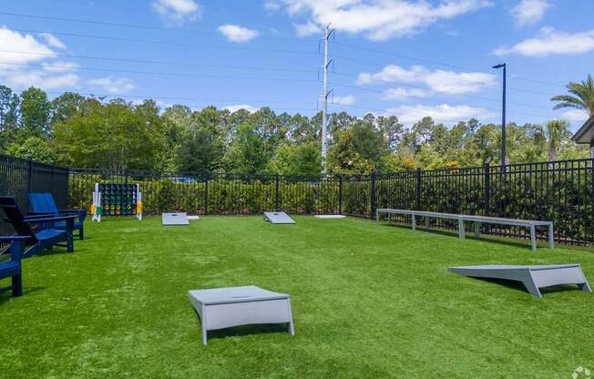 A backyard with a green lawn and a fence.