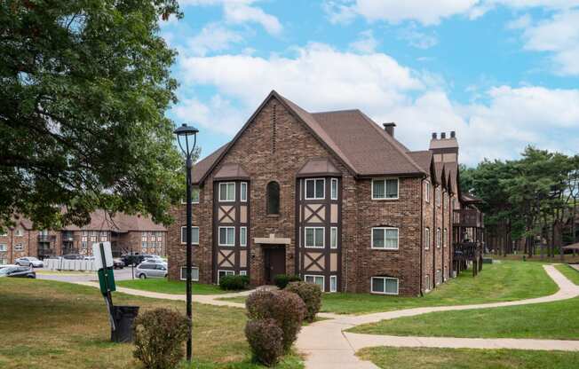 a large brick building with a sidewalk in front of it