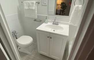 a small bathroom with a toilet sink and mirror