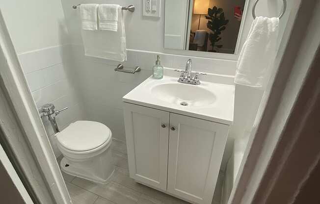 a small bathroom with a toilet sink and mirror