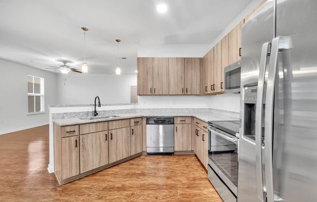 a kitchen with wooden cabinets and stainless steel appliances