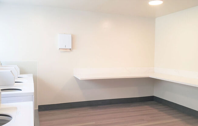 a laundry room with a washing machine and a shelf at Citra Apartments LLC, San Diego, CA, 92107