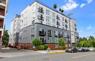 View of the property with grey and brick accents at Arabella Apartment Homes, Shoreline, 98155