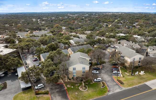 A bird's eye view of a residential area with houses and cars.