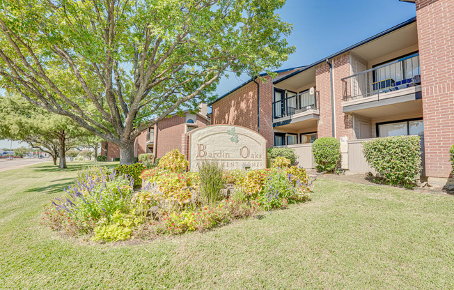 A building with a sign that says Berdine Oaks in front of it.