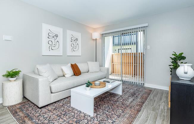 a living room filled with furniture and a large window