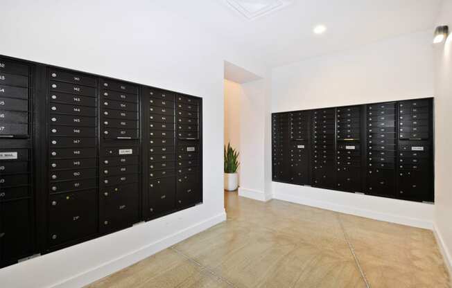 the room has a locker room with wooden floors and white walls