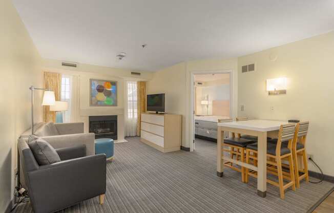 a living room and dining area in a hotel room