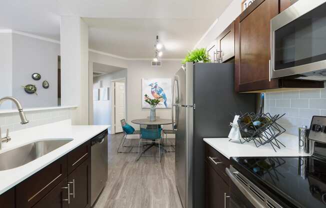 kitchen and dining room with stainless steel appliances at the district flats apartments