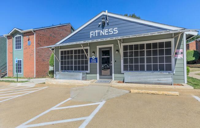 a dirt road in front of a building