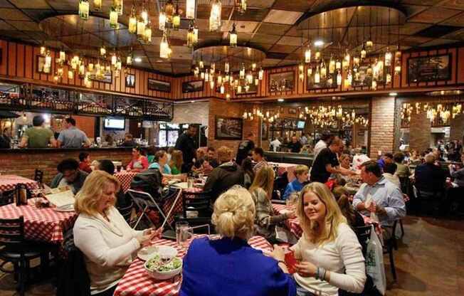 A group of people are sitting at tables in a restaurant.
