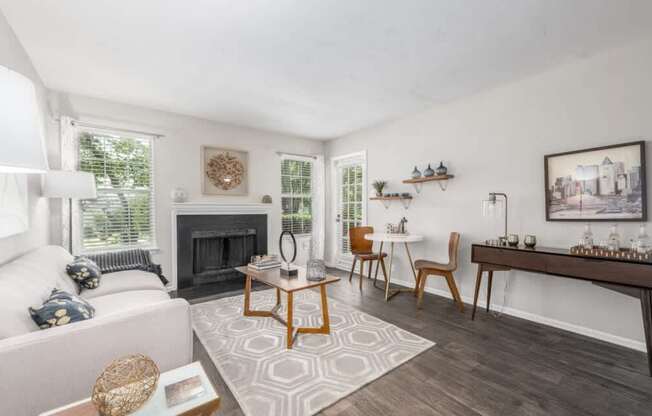 A living room with a fireplace and a white couch.
