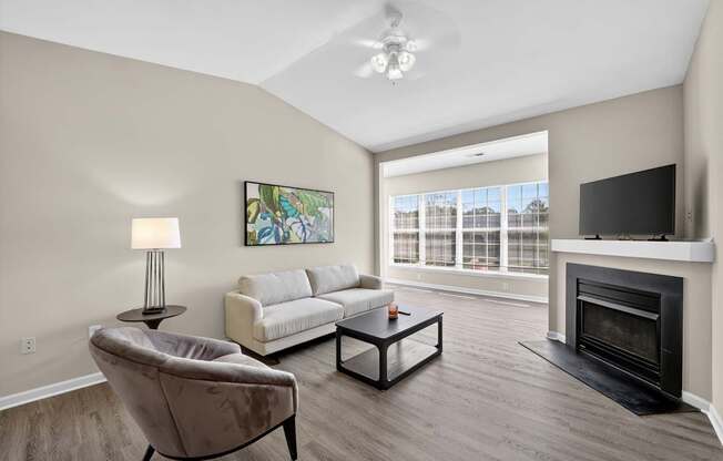 A classic style living room with a fireplace and a painting on the wall.