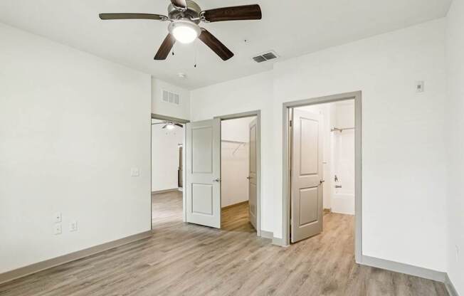 Royal Palm bedroom with a ceiling fan and vinyl wood flooring at Oakleaf Plantation apartments in Jacksonville, FL.