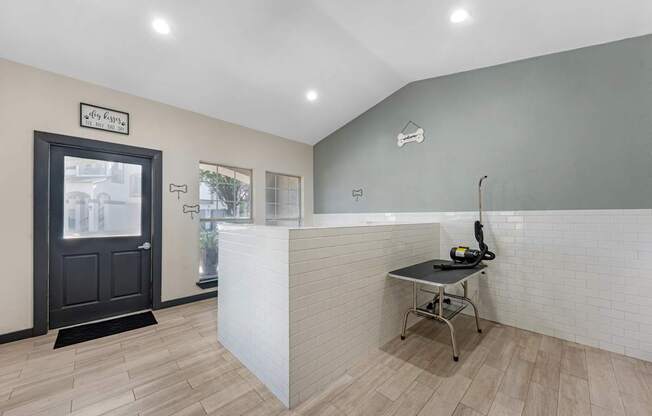 A reception area with a black door and a white reception desk.