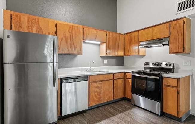 A kitchen with wooden cabinets and stainless steel appliances.