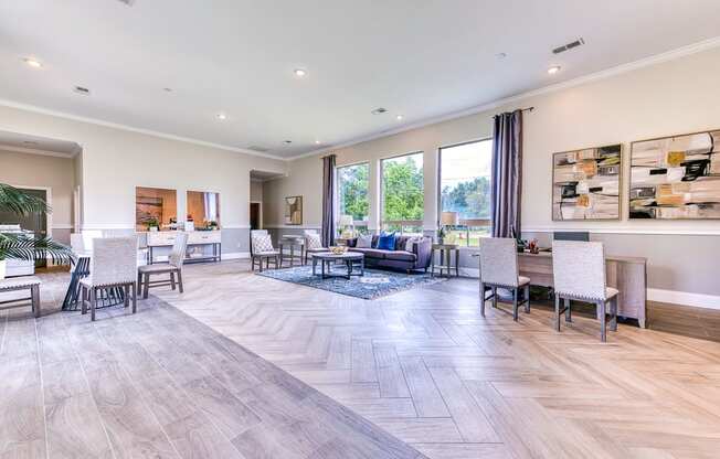 A spacious living room with a grey floor and white walls.
