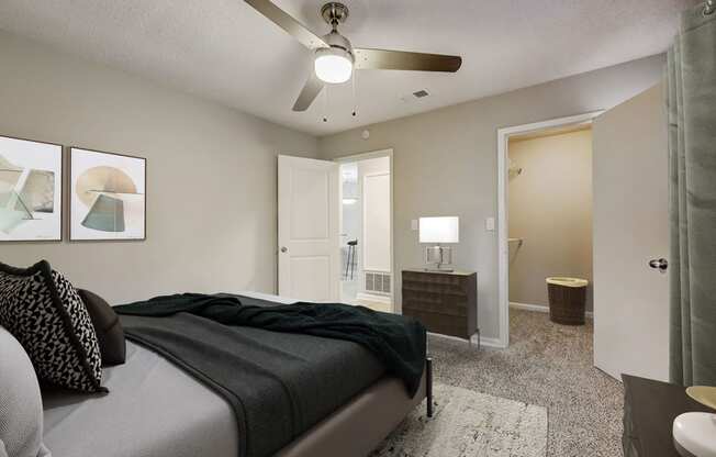 a bedroom with a bed and a ceiling fan