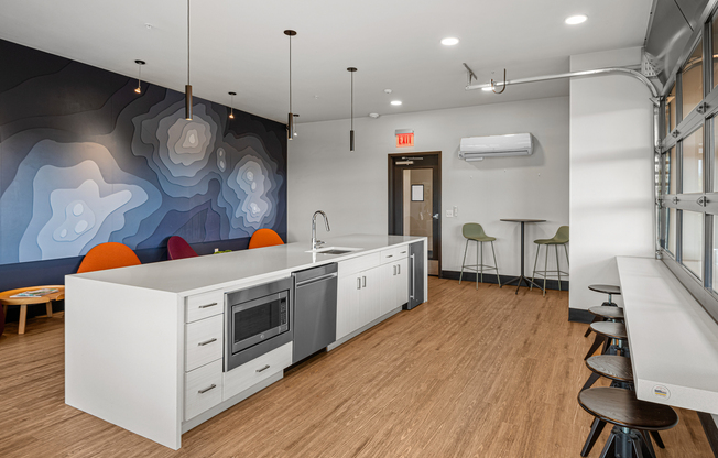 Another angle of kitchenette and seating area in the rooftop indoor-outdoor resident lounge