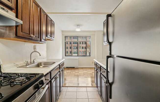 A kitchen with a black stove top oven and a black refrigerator.